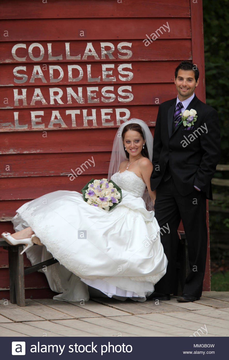 A Bride In A Traditional White Wedding Dress Holding A Bouquet Of