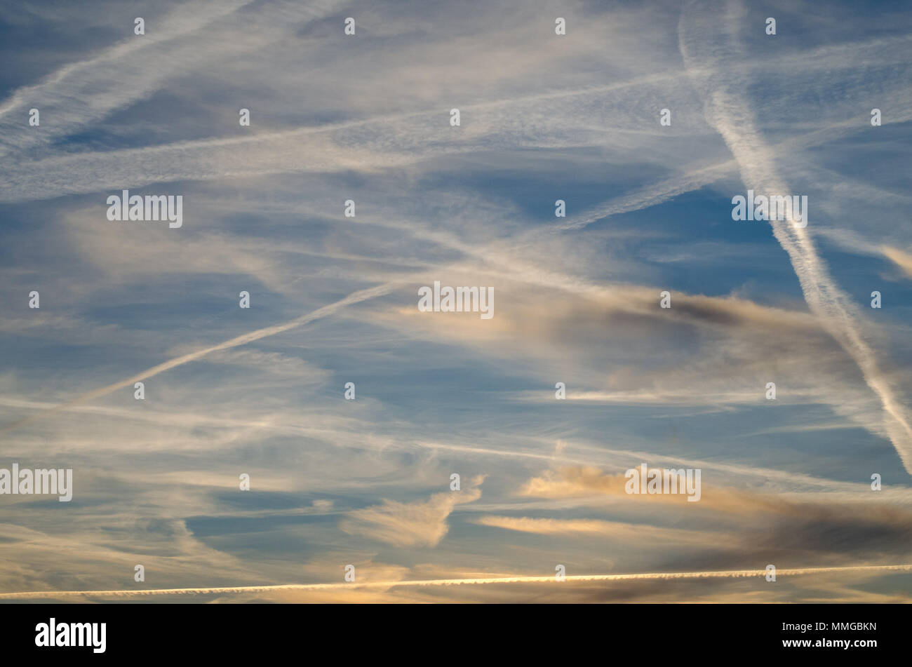 Blue sky with airplane trails and lines Stock Photo
