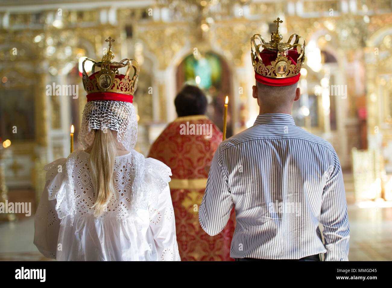 Bride and groom with crowns on orthodox engagement ceremony in the church  Stock Photo - Alamy, image size:1300x956