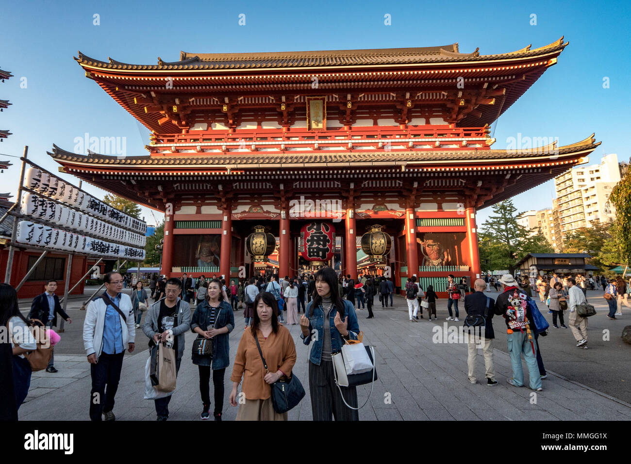 Visitors walk around the Hōzōmon, or Treasure House Gate, at
