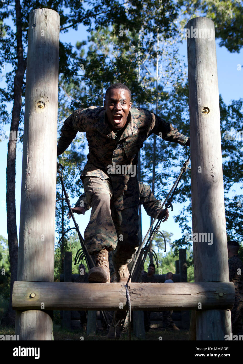 A U.S. Marine assigned to Ground Supply School (GSS), Marine Corps Combat Service Support Schools, crosses a rope bridge during the GSS Spartan Challenge at Camp Johnson, N.C., Oct. 18, 2017. The Marines of GSS conducted different obstacle courses to ensure combat conditioning and unit cohesion. (U.S. Marine Corps photo taken by Lance Cpl. Luis E. Zamot III) Stock Photo