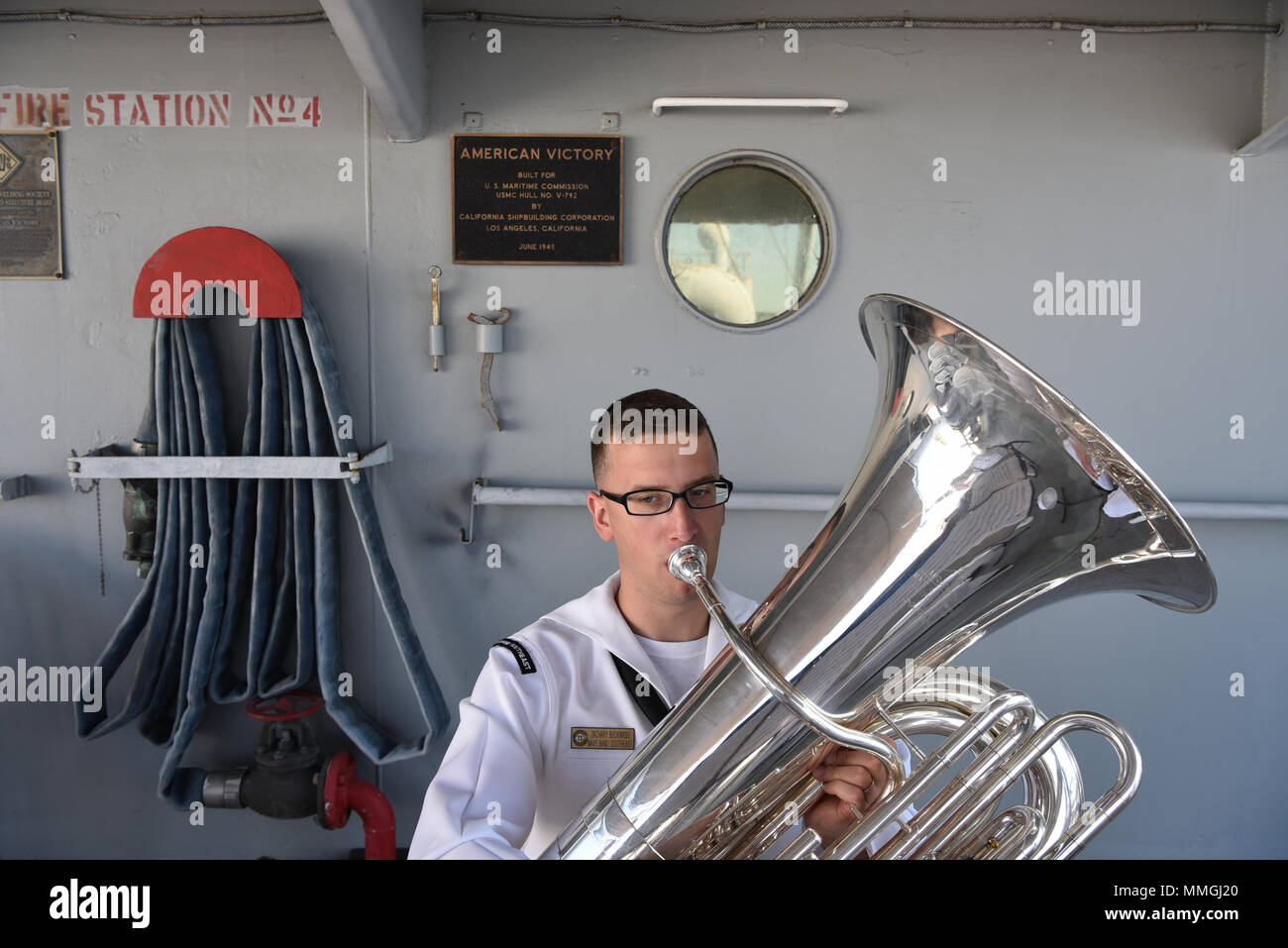 180507-N-IG616-3860 TAMPA, Florida (May 7, 2018)  Musician 3rd Class Zachary Buckwash, from Dillsburg, Pennsylvania performs on tuba with the Navy Band Southeast 'Windward Brass Quintet' for the Navy Week Tampa Opening Ceremony aboard the SS American Victory Mariners Museum.  Navy Weeks are designed to connect the public with Navy Sailors, programs and equipment throughout the country.  (U.S. Navy/Released) Stock Photo