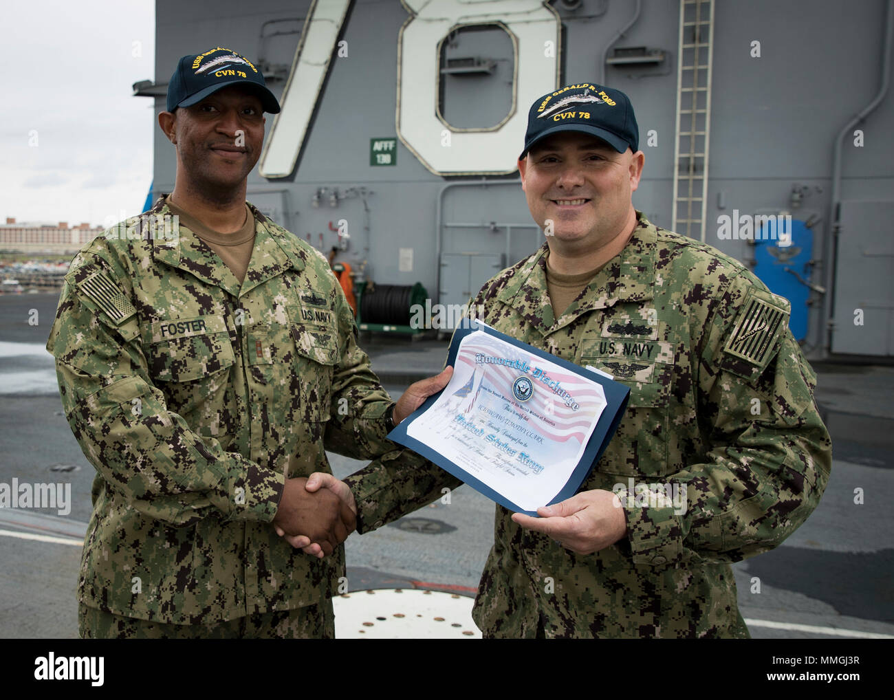 NORFOLK, Va. (May 07, 2018) -- Interior Communications Electrician 1st  Class Timothy Clark, from Hampton, Virginia, assigned to USS Gerald R.  Ford's (CVN 78) air department, receives an honorable discharge certificate  from