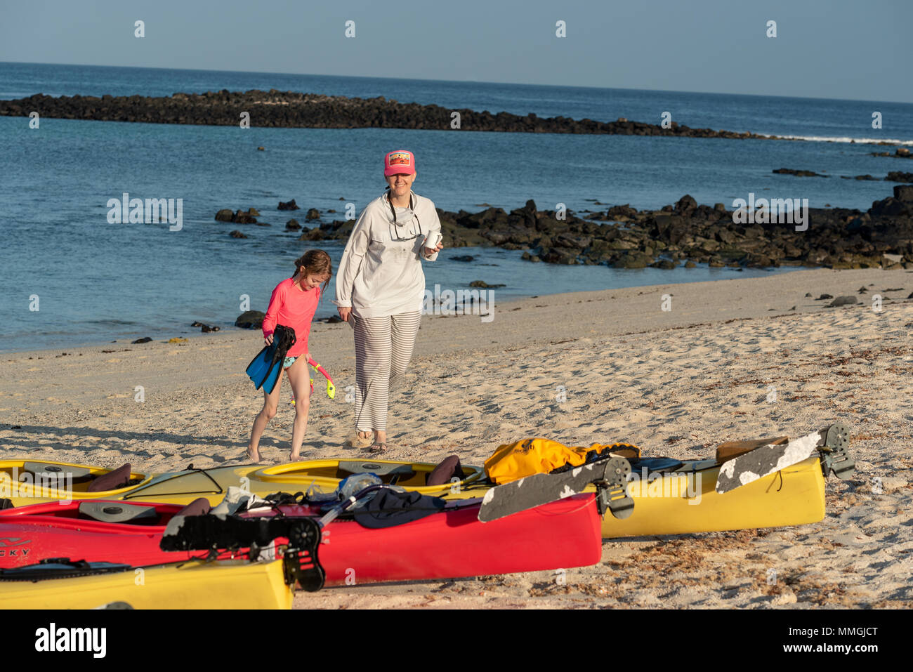 Mother and daughter on beach during a sea kayak trip in the Galapagos Islands, Ecuador. Stock Photo