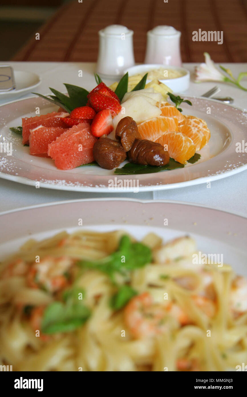 Close-up of fruit salad dessert with big shrimp pasta Stock Photo