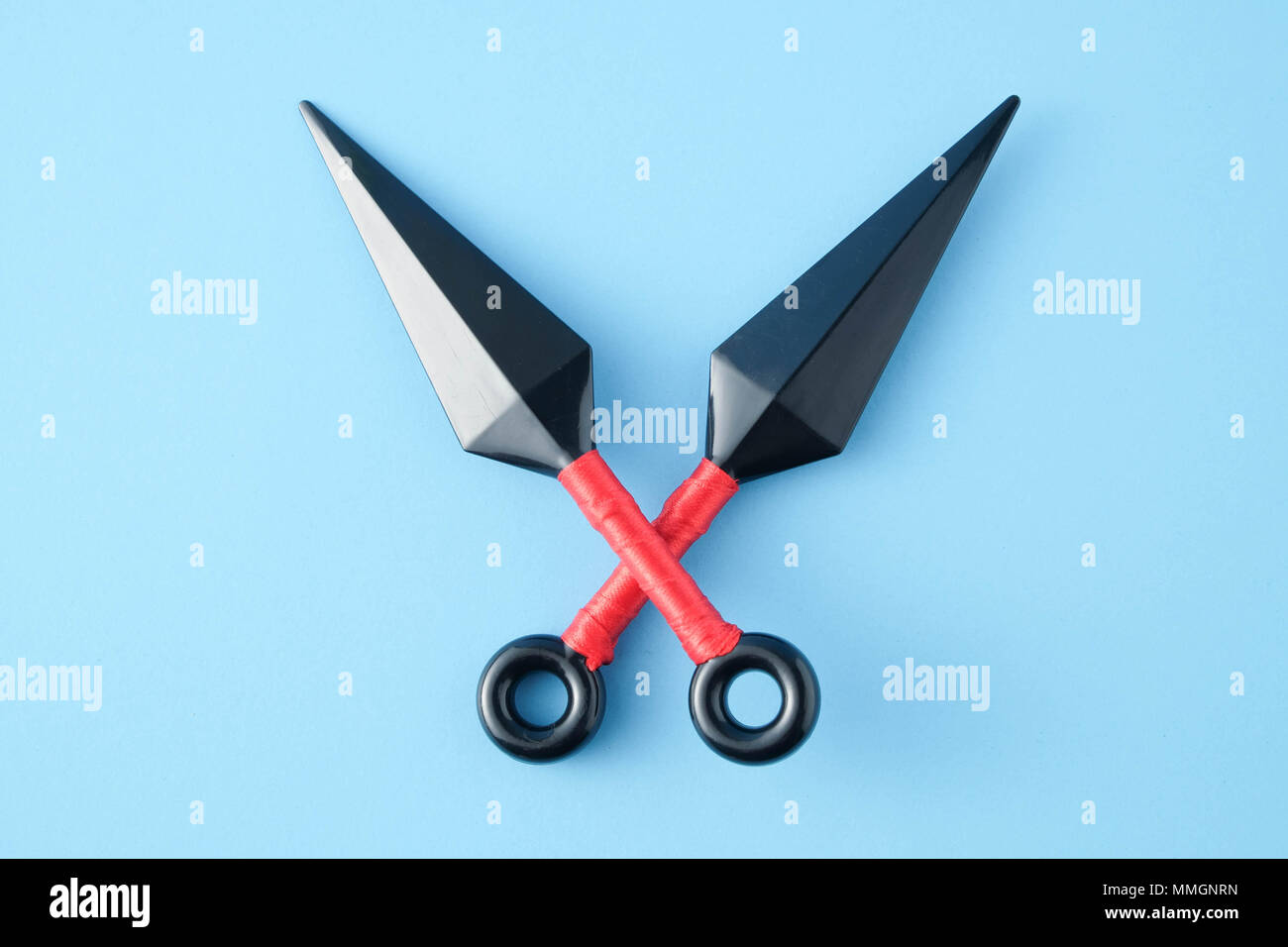 To throw ninja weapons isolated on blue paper background Stock Photo
