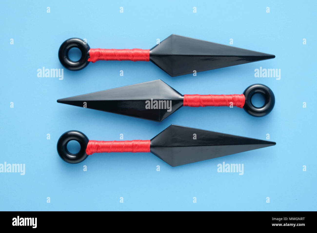 To throw ninja weapons isolated on blue paper background Stock Photo