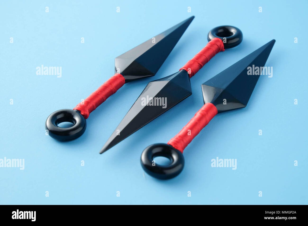 To throw ninja weapons isolated on blue paper background Stock Photo