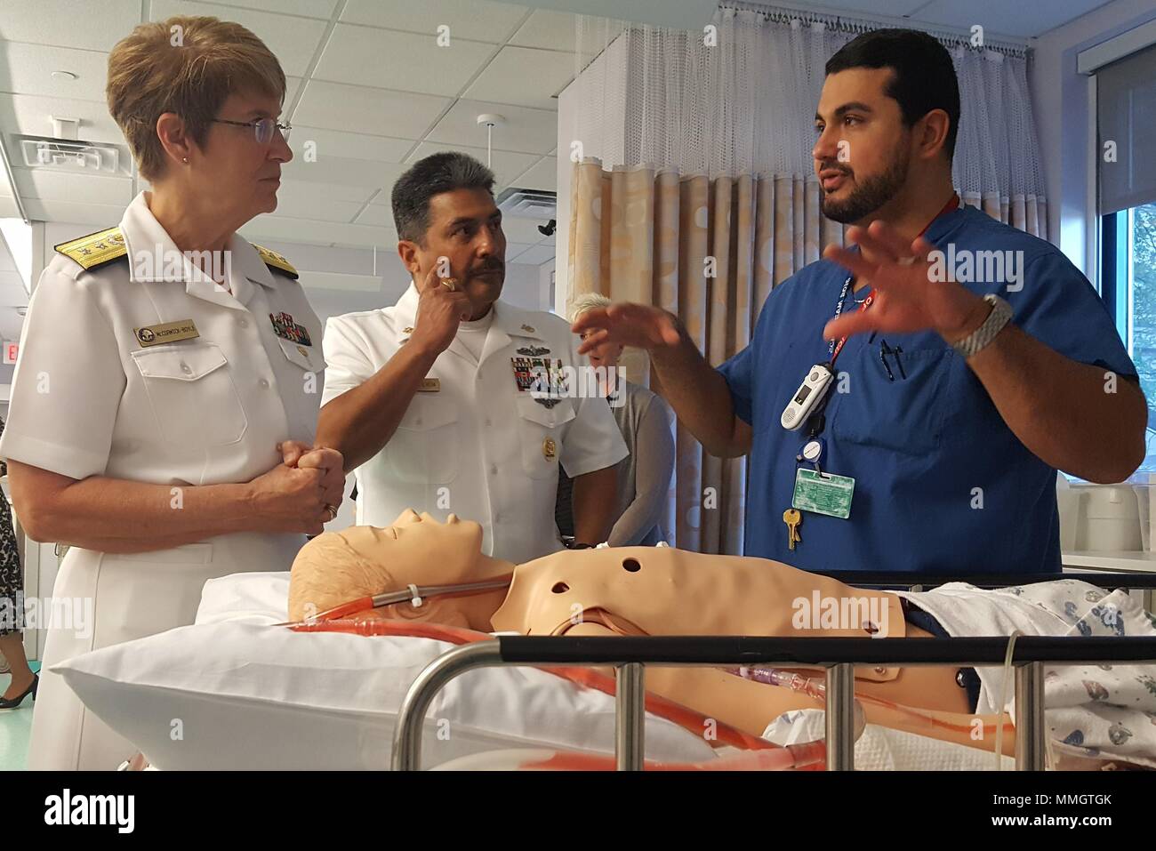 Guillermo Herrera (right), Cook Children’s Hospital respiratory therapist and extracorporeal membrane oxygenation (ECMO) coordinator, explains to Rear Adm. Rebecca McCormick-Boyle, commander, Navy Medicine Education, Training and Logistics Command (NMTLC) (left); and Command Master Chief Petty Officer Mitchell Sepulveda, NMETLC Command Master Chief, how some of the hospital's medical simulation training equipment operates. McCormick-Boyle and Sepulveda visited Cook Children’s during Fort Worth Navy Week 2017. Stock Photo