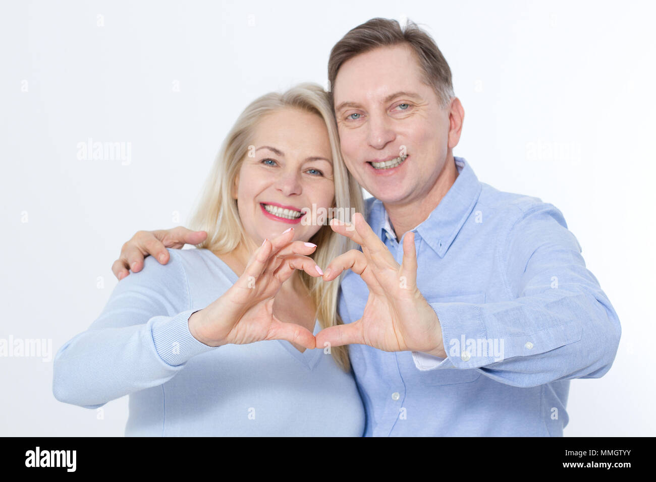 Closeup of couple making heart shape with hands. Selective focus Stock ...