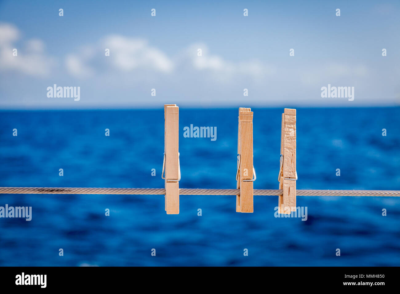 Cllose-up image of wooden cloth pins on a sailboat railing Stock Photo