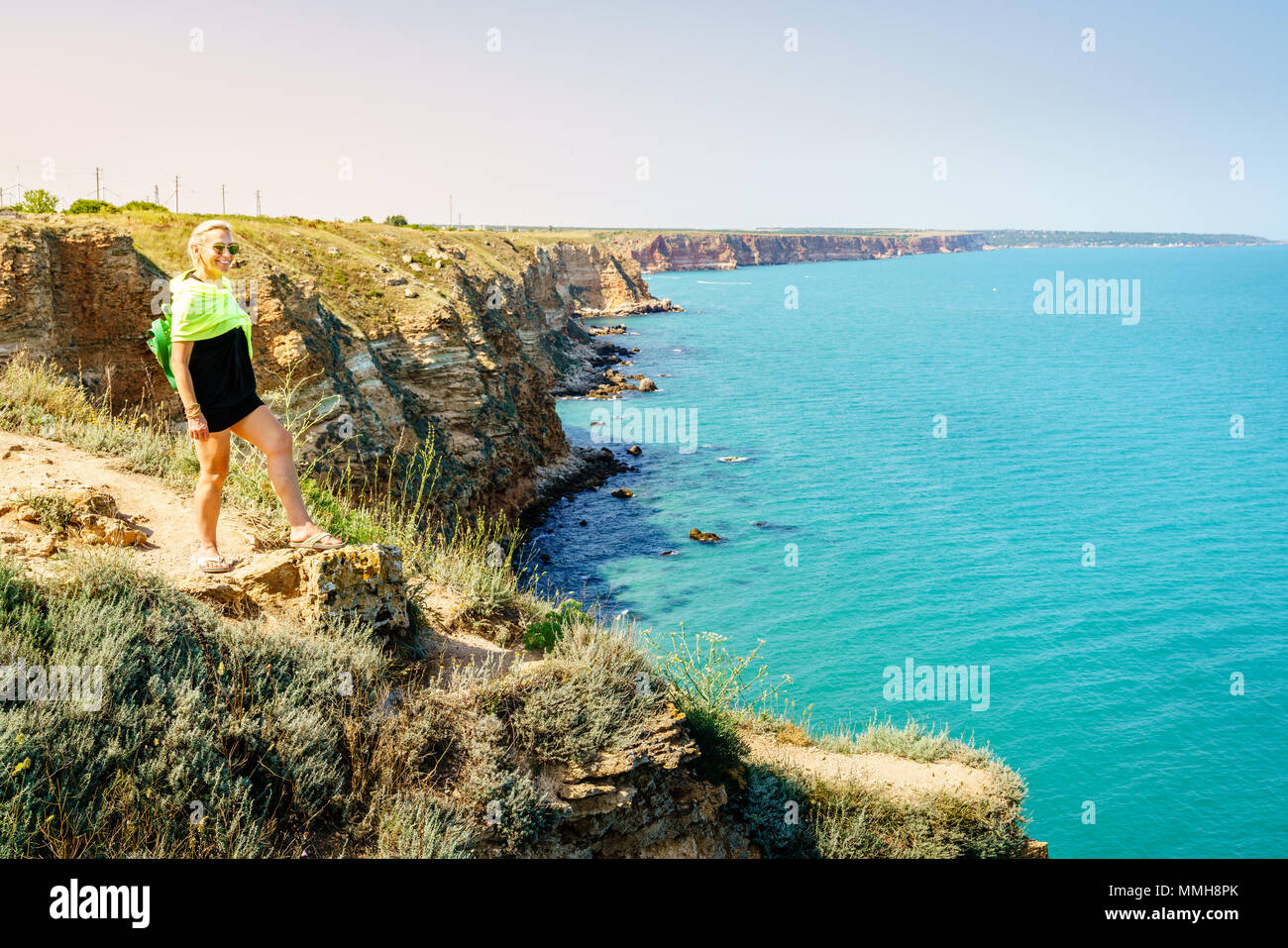 Happy woman admiring the view from Cape Kaliakra, Bulgaria Stock Photo