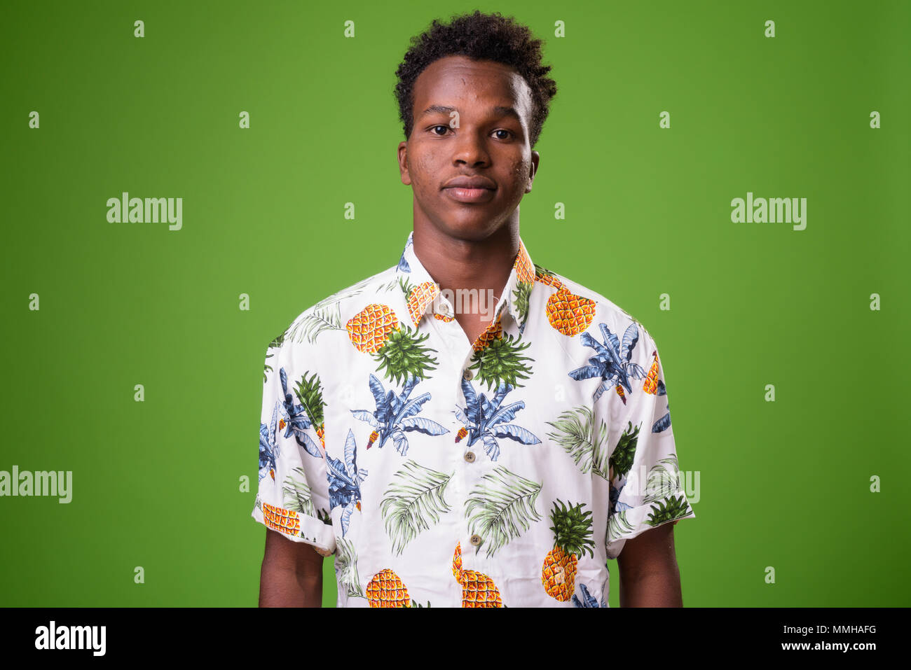 Young African tourist man ready for vacation against green backg Stock Photo