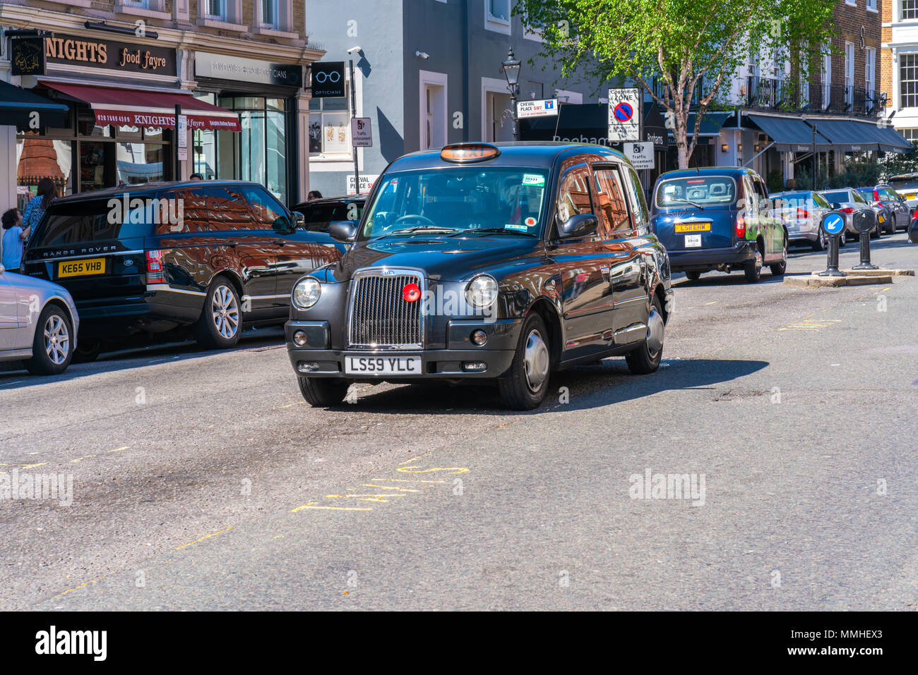 LONDON MAY 05, 2018: The iconic London black cab parked on a street in Knightsbridge, London.The traditional black cabs are specially constructed vehi Stock Photo