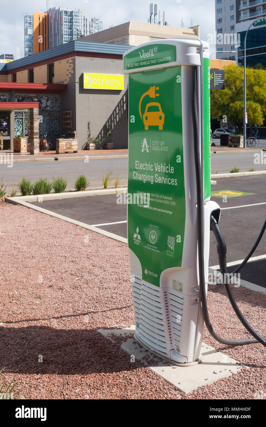 View of an electric car charging station located next to a car park