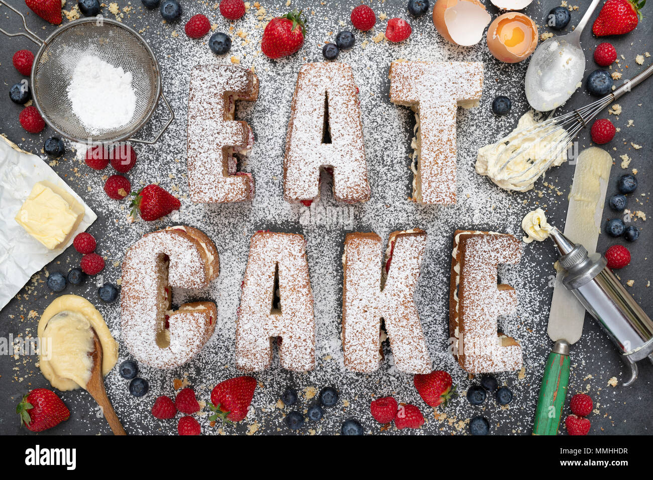 Victoria sponge cakes spelling the word EAT CAKE with ingredients from above. Pattern Stock Photo