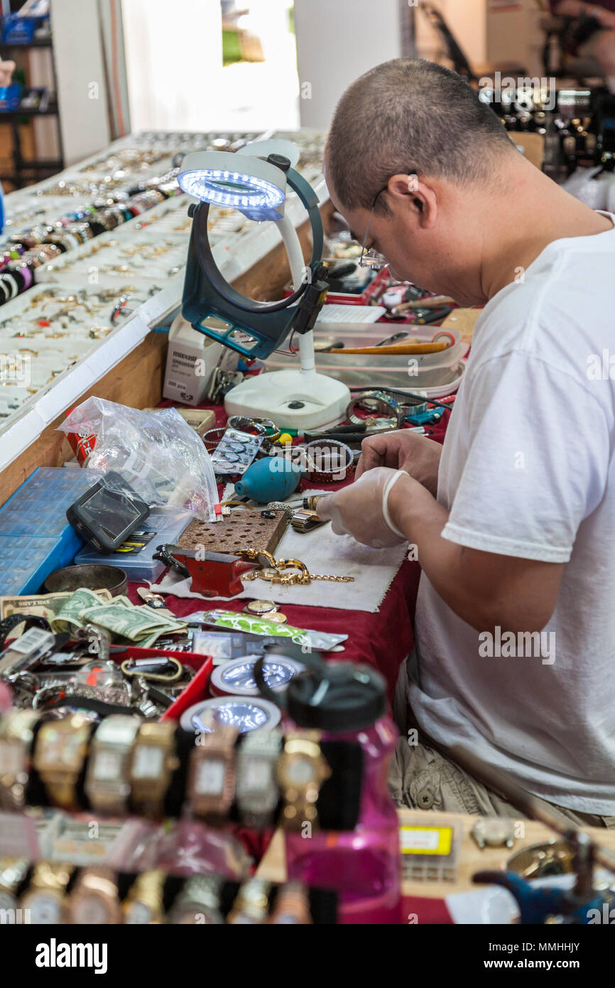 Shop owner repairing watches at the Markets of Marion flea market near Ocala, Florida Stock Photo