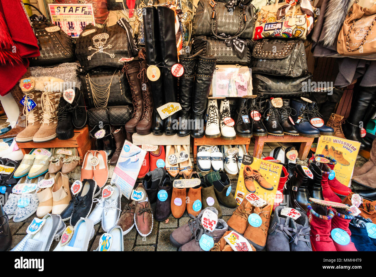 Tokyo, Harajuku, Takeshita street. Women's clothing display outside shop, shoes and handbags on pavement. Stock Photo