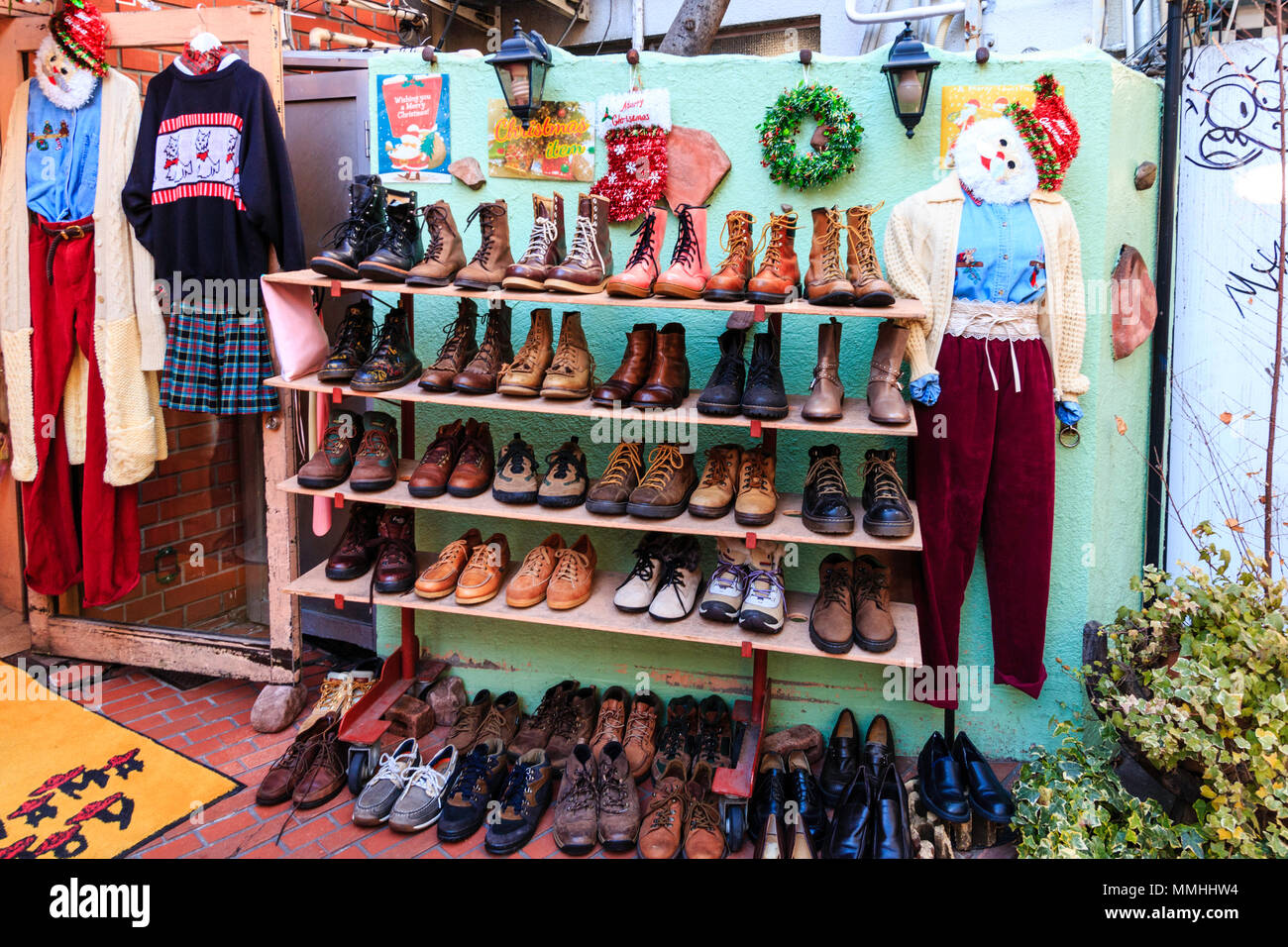 Tokyo, Harajuku, Takeshita street. Panama Boy used store, exterior. Rack of boots on sale. Christmas decorations. Stock Photo