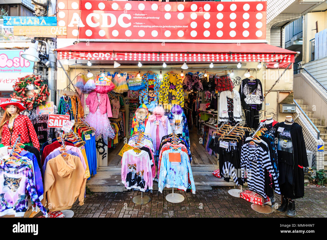 Tokyo, Harajuku, Takeshita street. Small branch of ACDC Rag famous fashion boutique. Clothing on many racks on pavement outside shop and entrance. Stock Photo