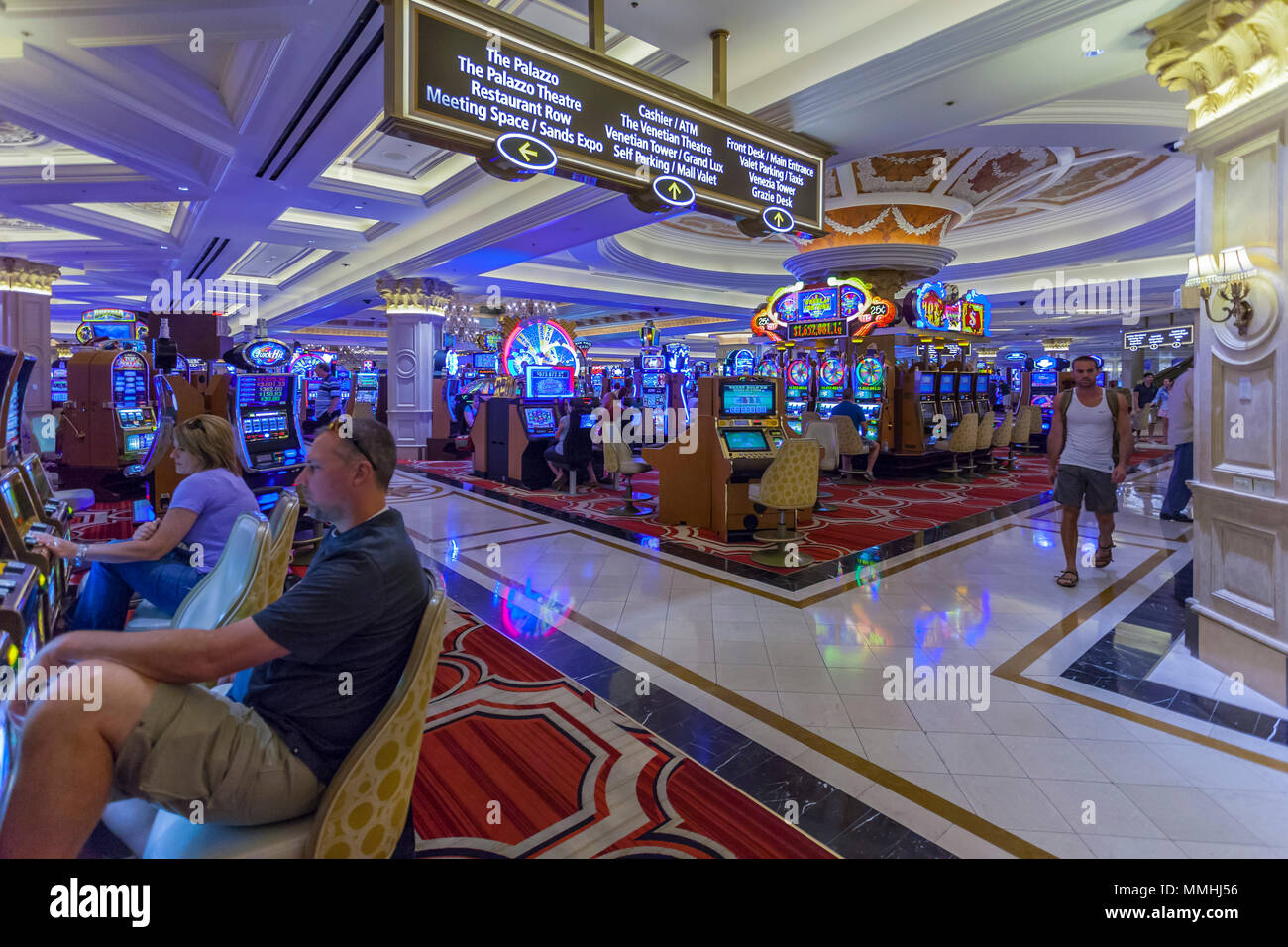 Tourists playing slot machines at the Venetian Resort Hotel Casino on the Las Vegas Strip in Paradise, Nevada Stock Photo