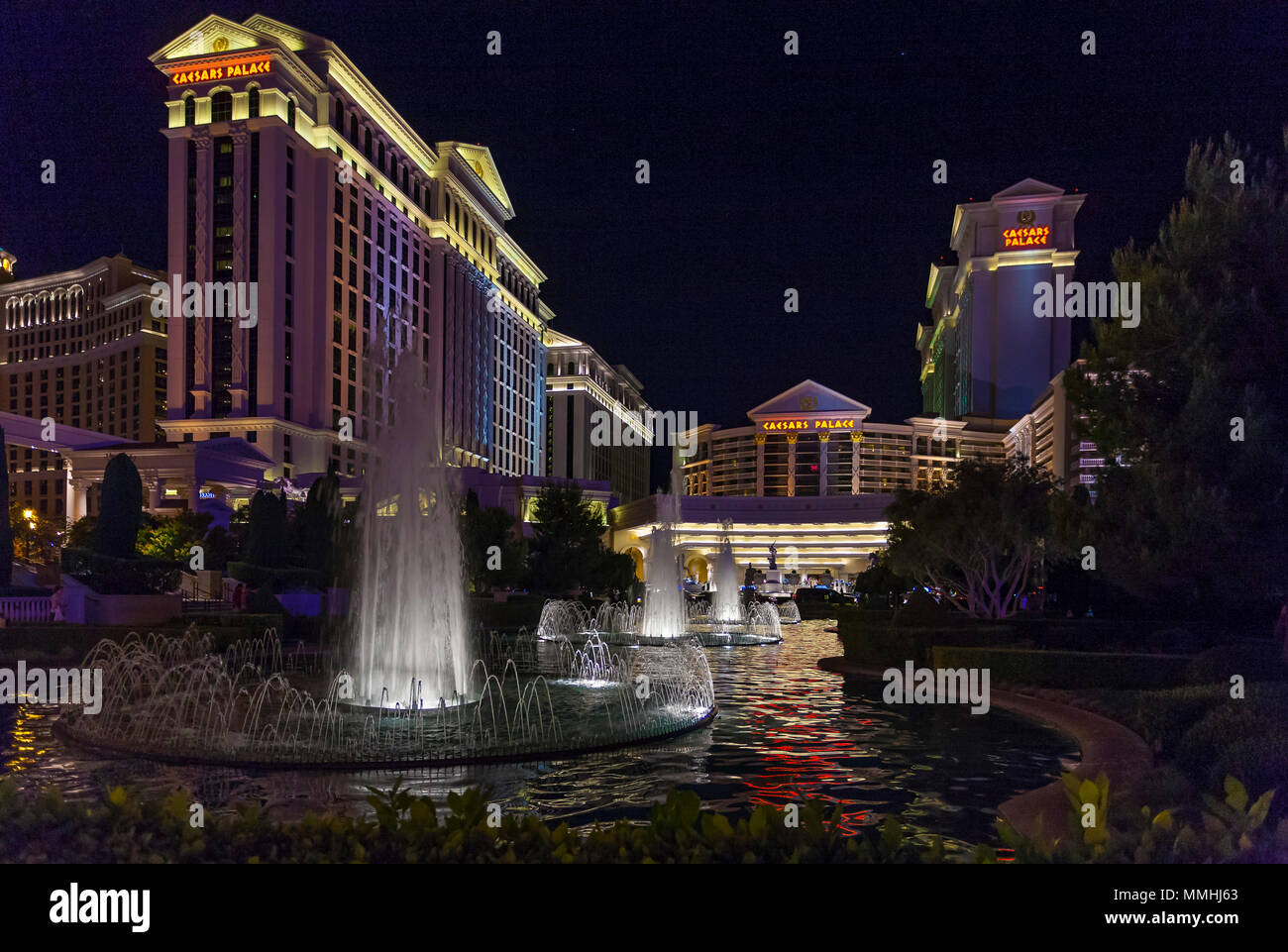 Fountains in front of Caesars Palace Hotel and Casino on the Las Vegas Strip in Paradise, Nevada are dramatically lit at night Stock Photo