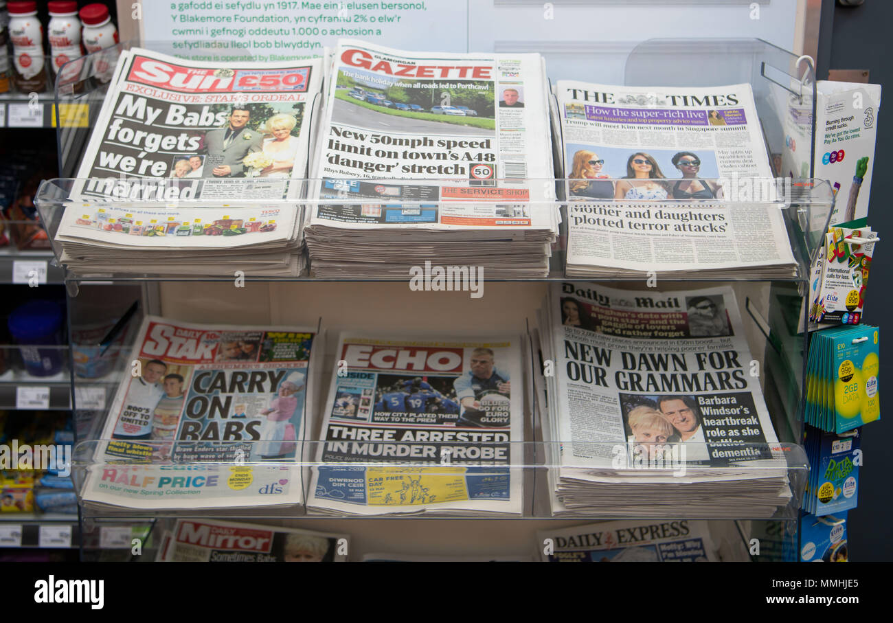 Local and national newspapers on sale in a newsagent shop. Stock Photo