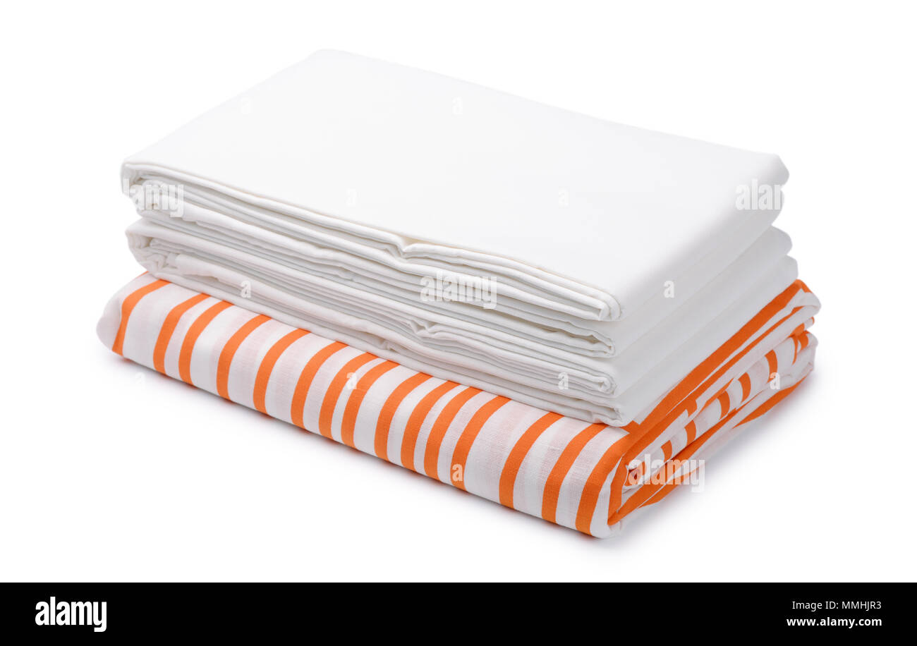 Stack of folded white and color bedding sheets isolated on white Stock Photo
