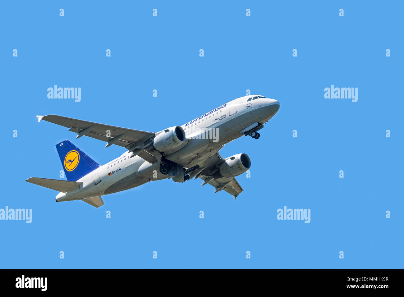 Airbus A319-100, narrow-body, commercial passenger twin-engine jet airliner from Lufthansa German Airlines in flight against blue sky Stock Photo