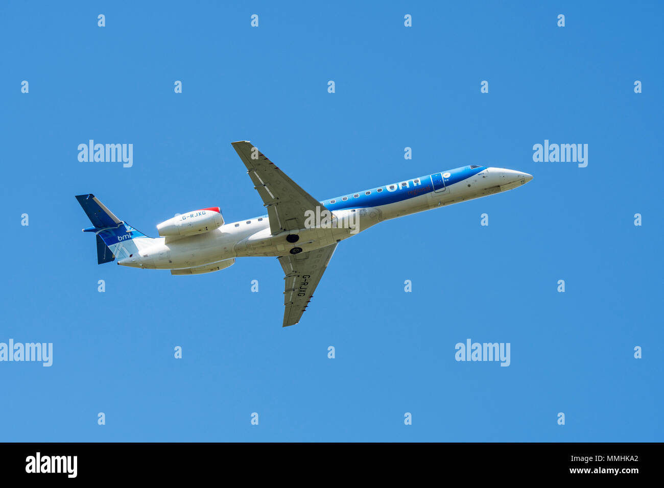 Embraer ERJ-145-EP, twin-engine regional jet from British Midland Regional Limited / Flybmi, British regional airline in flight against blue sky Stock Photo