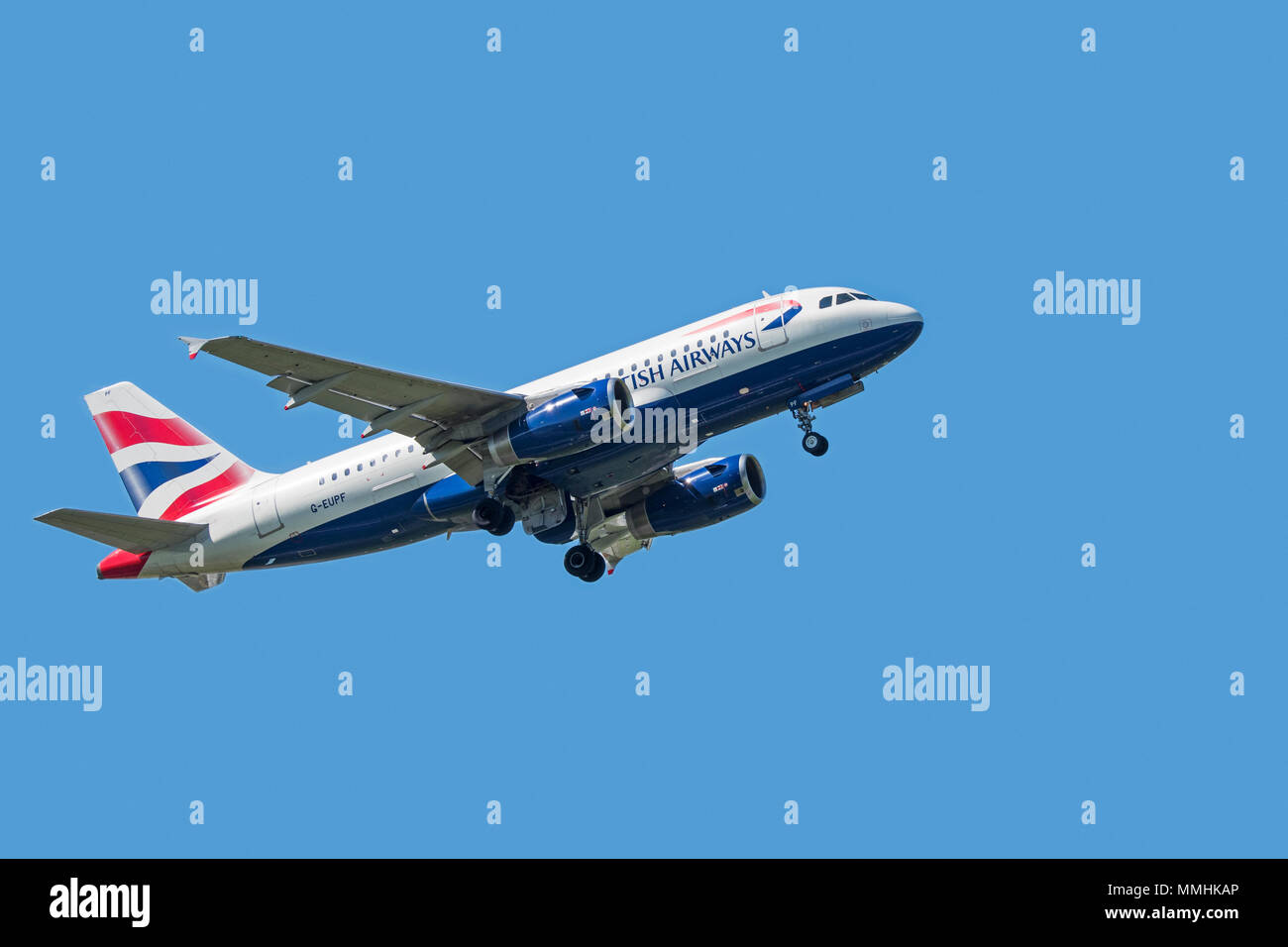Airbus A319-131, narrow-body, commercial passenger twin-engine jet airliner from British Airways in flight against blue sky Stock Photo