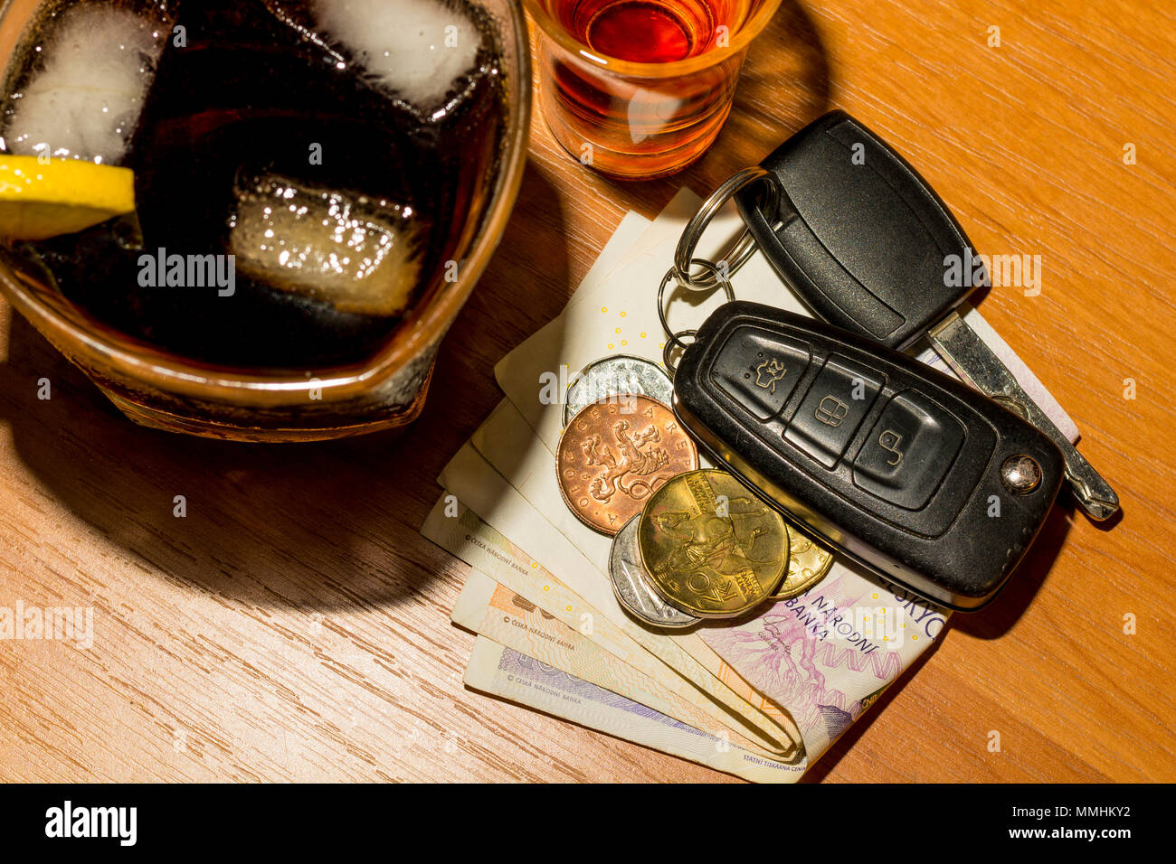 Whiskey, cocktail, money and car keys at the bar. Alcoholic glasses and car keys. Do not drink alcohol while driving a car. Stock Photo