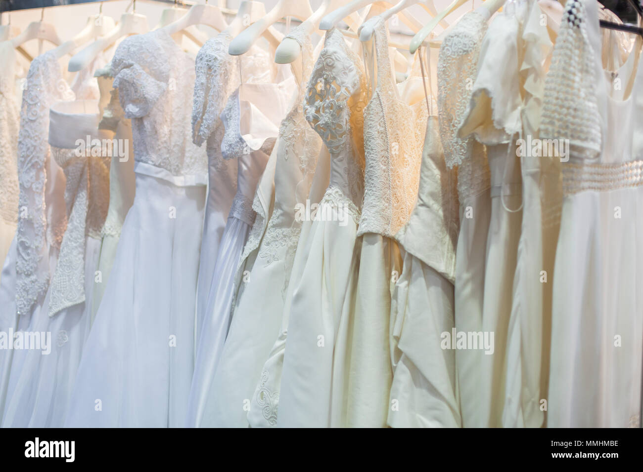 Beautiful wedding dresses hang on hangers on the rack Stock Photo Alamy