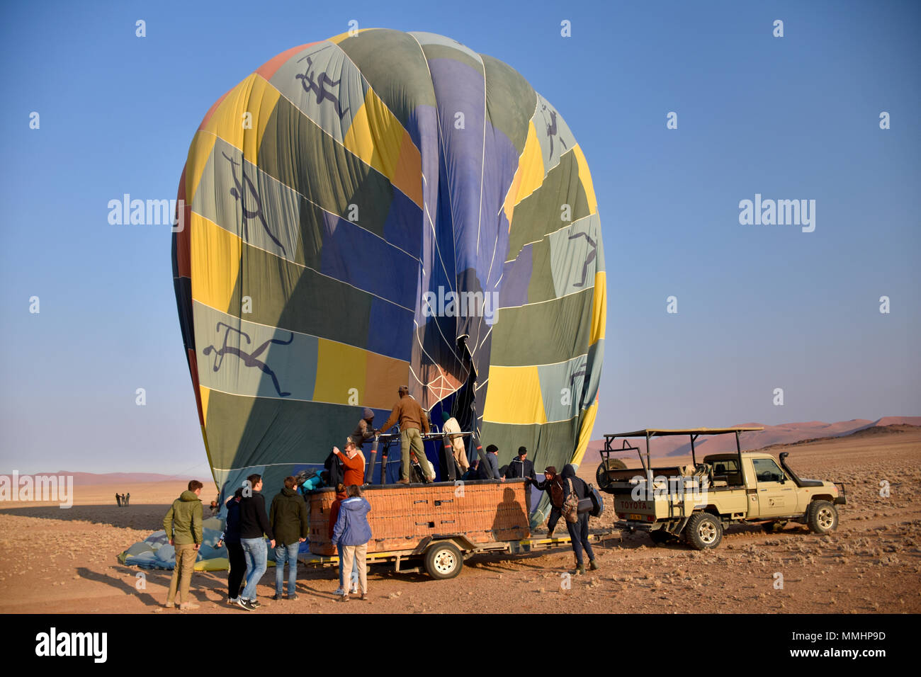 Hot air balloon lands on top of a car in the Namib Desert, Sossusvlei area, Sesriem, Namibia Stock Photo
