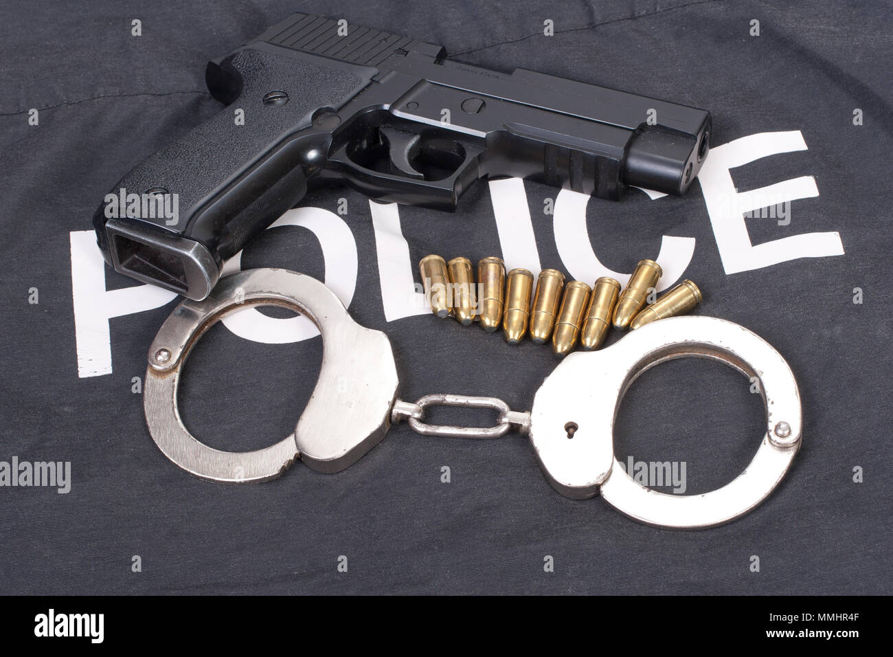 police concept with gun ammo and handcuffs Stock Photo - Alamy
