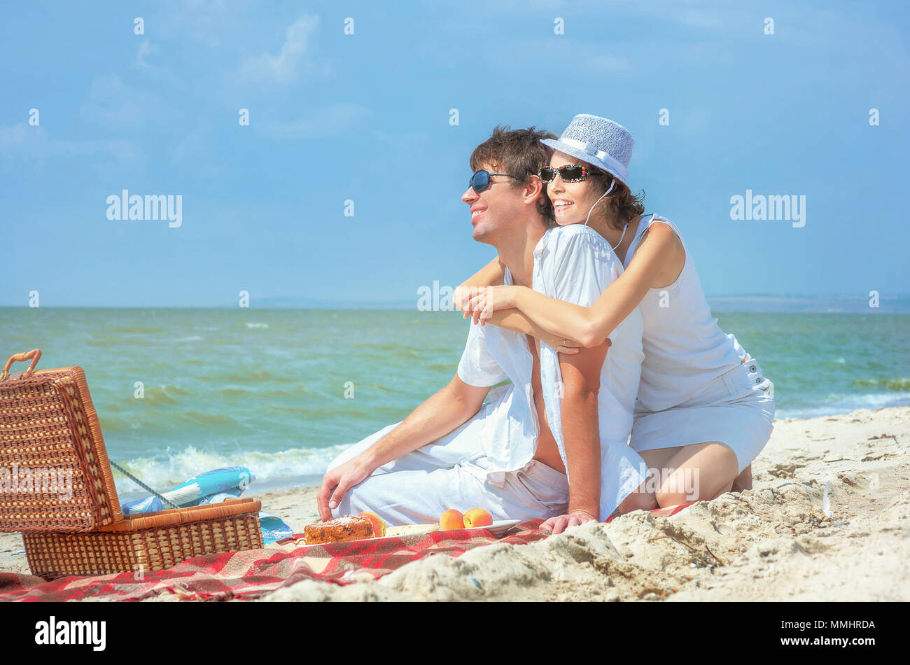 Beautiful young stylish couple enjoying picnic on beach Stock ...