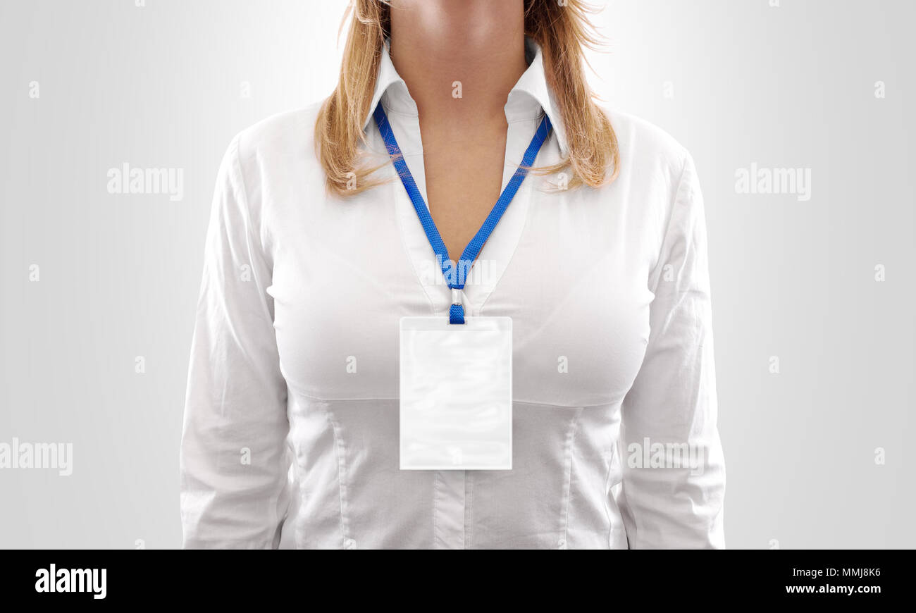 Woman wear big blank white vertical badge mockup, stand isolated. Name tag on neck and chest. Person identity label. Women in shirt uniform with empty id card mock up. Bussinesswoman lanyard design. Stock Photo