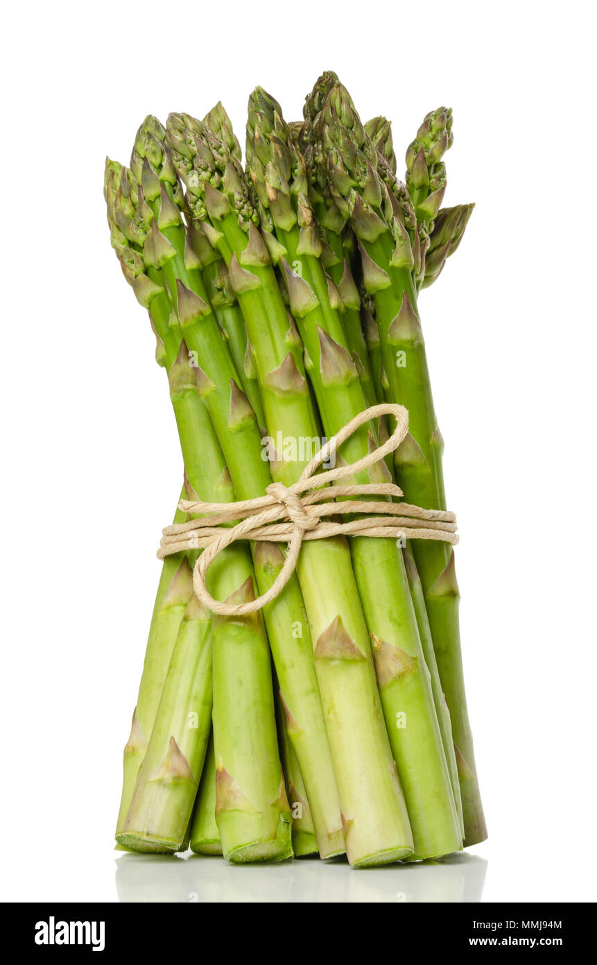 Bundle of fresh green asparagus shoots, upright standing. Sparrow grass. Cultivated Asparagus officinalis. Spring vegetable with thick stems. Stock Photo