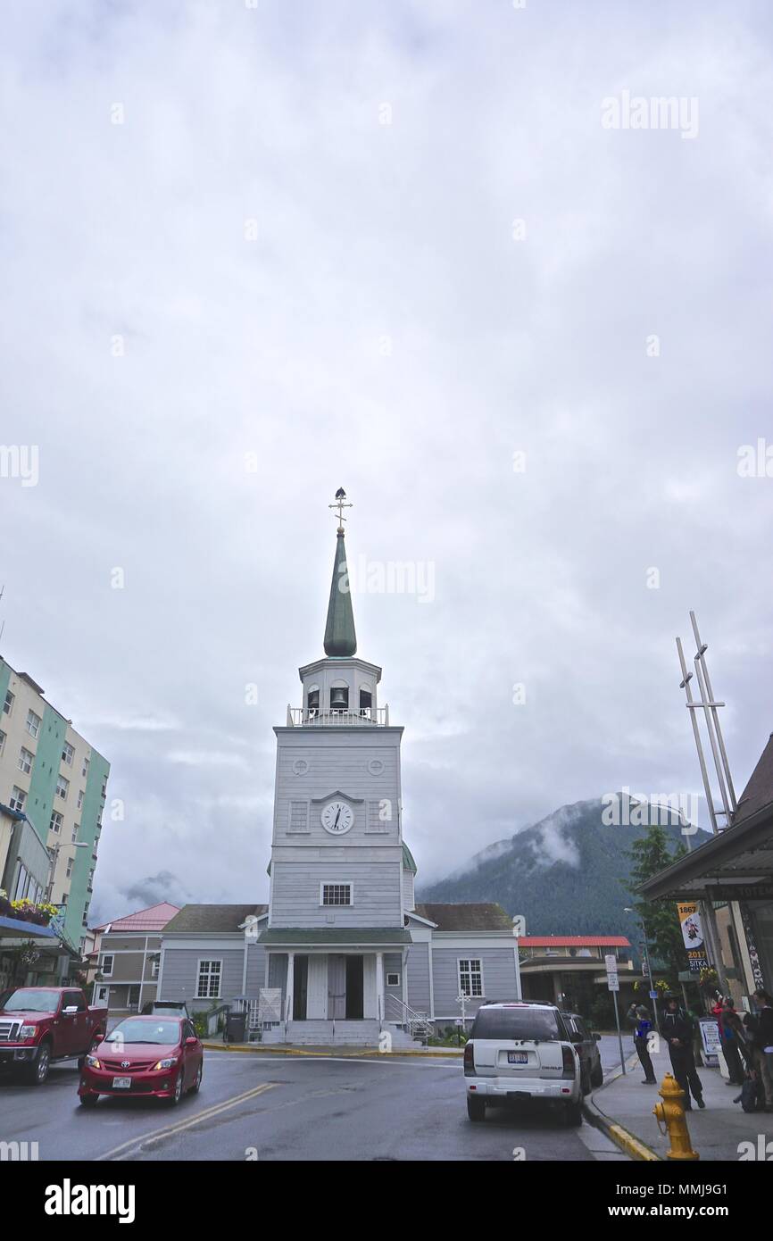 Sitka, Alaska, USA: People stop on the street to photograph two bald eagles (Haliaeetus leucocephalus) on the spire of St. Michael’s Cathedral. Stock Photo