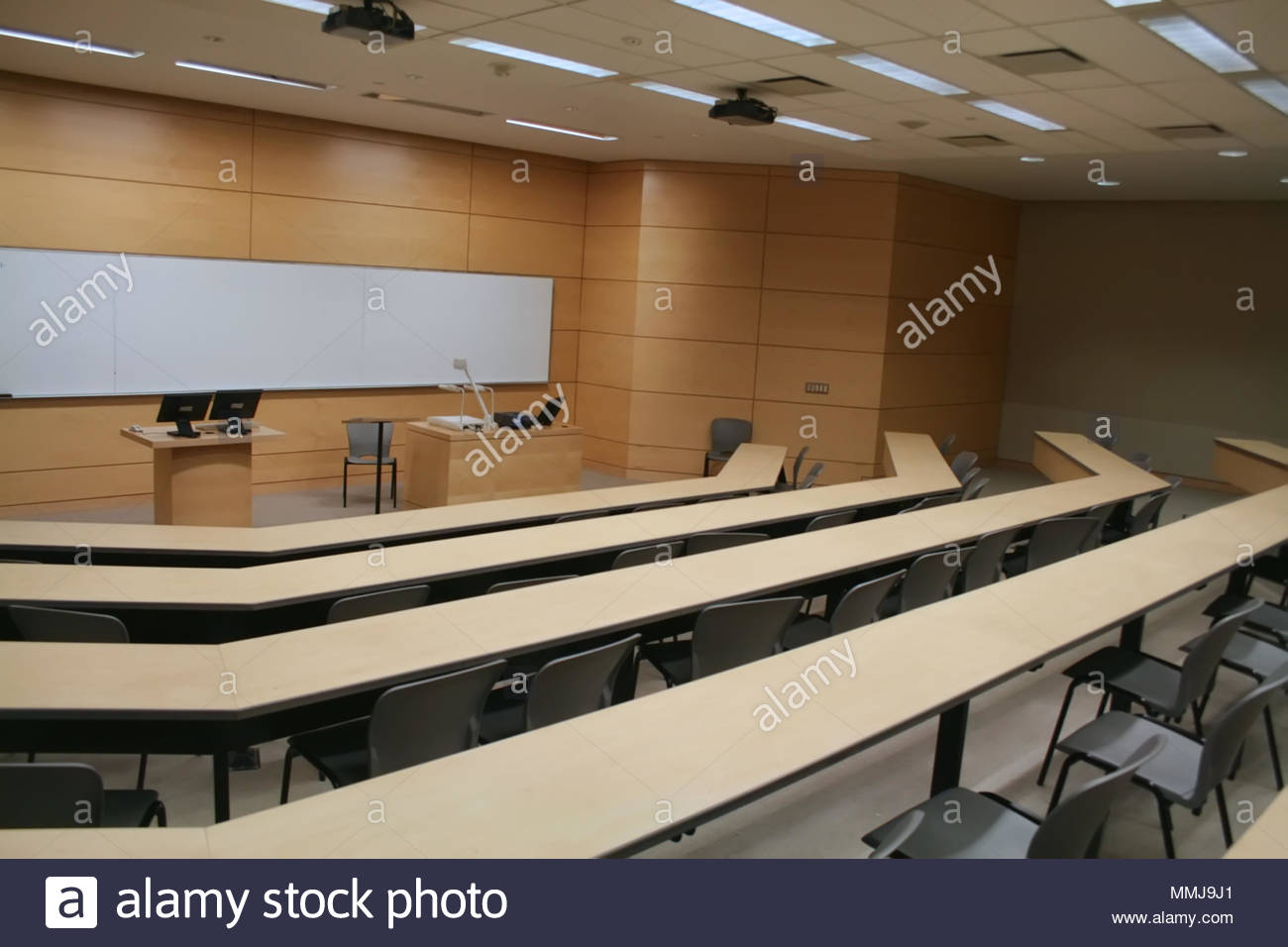 An Empty University Lecture Hall Filled With Desks And Chairs