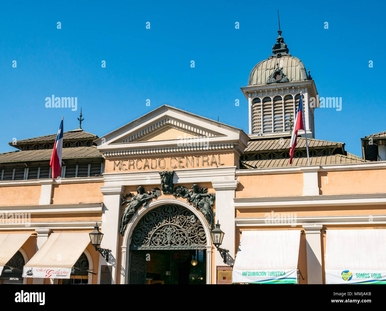 Historic old Central Market building, Santiago, Chile, with Chilean flags and blue sky Stock Photo