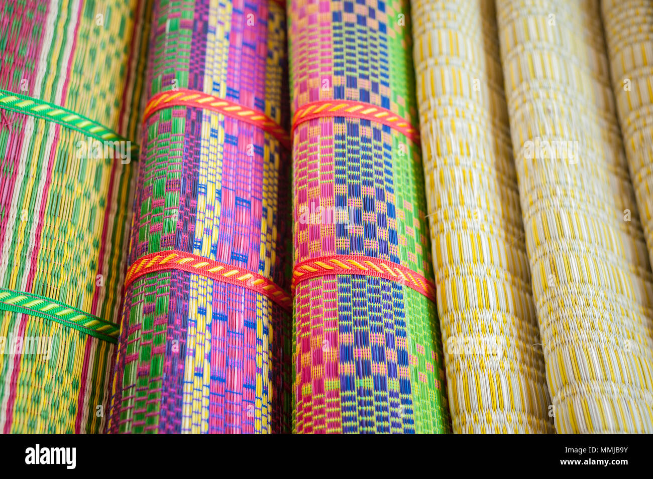 Coloful woven mats made from dry reed, local homemake of Thailand Stock
