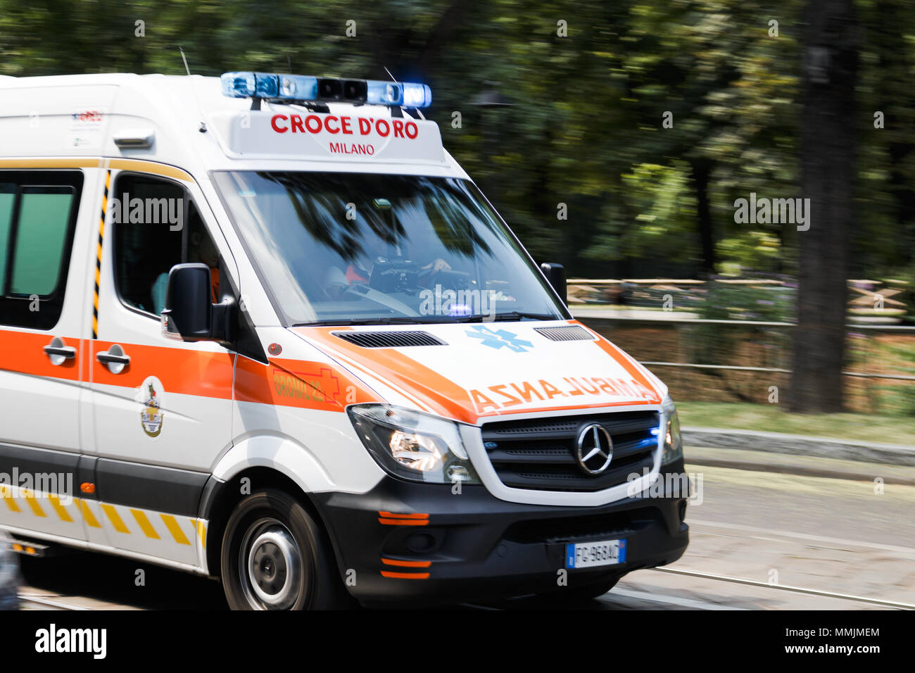 An Italian ambulance speeding through traffic in daytime. Stock Photo