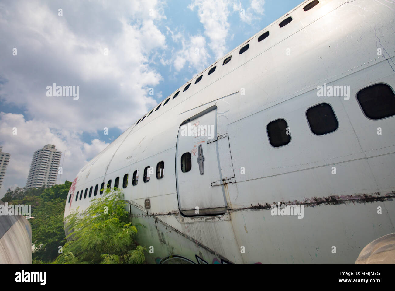 Remains of a wrecked and graffitied Boeing 747 and two McDonnell Douglas MD-80s in a field in Bangkok, Thailand never to be flown again. Stock Photo