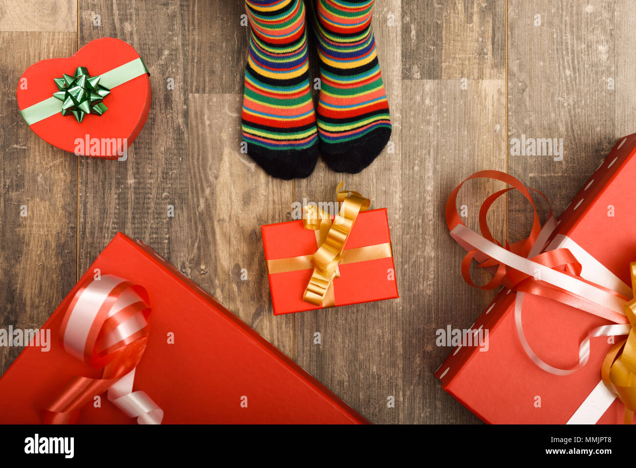 Feet of little children on wood floor. Christmas holidays concept Stock Photo