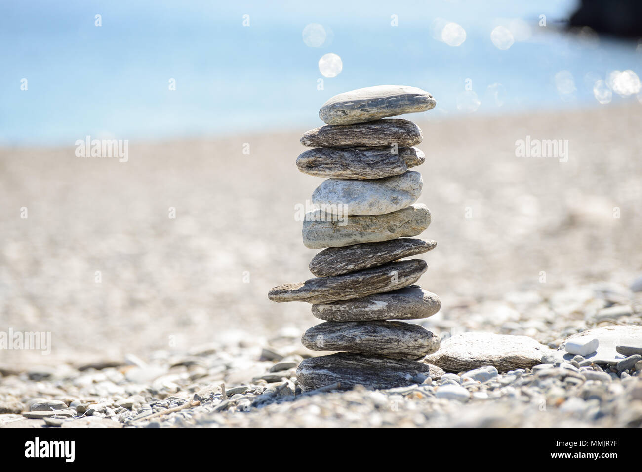 Pebbles in balancing on the sea coast Stock Photo - Alamy