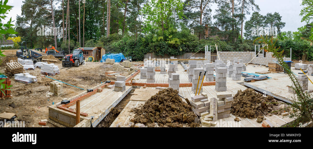 Breeze blocks stacked on the floor of a new house under construction on a residential suburban garden infill building site, Surrey, southeast England Stock Photo