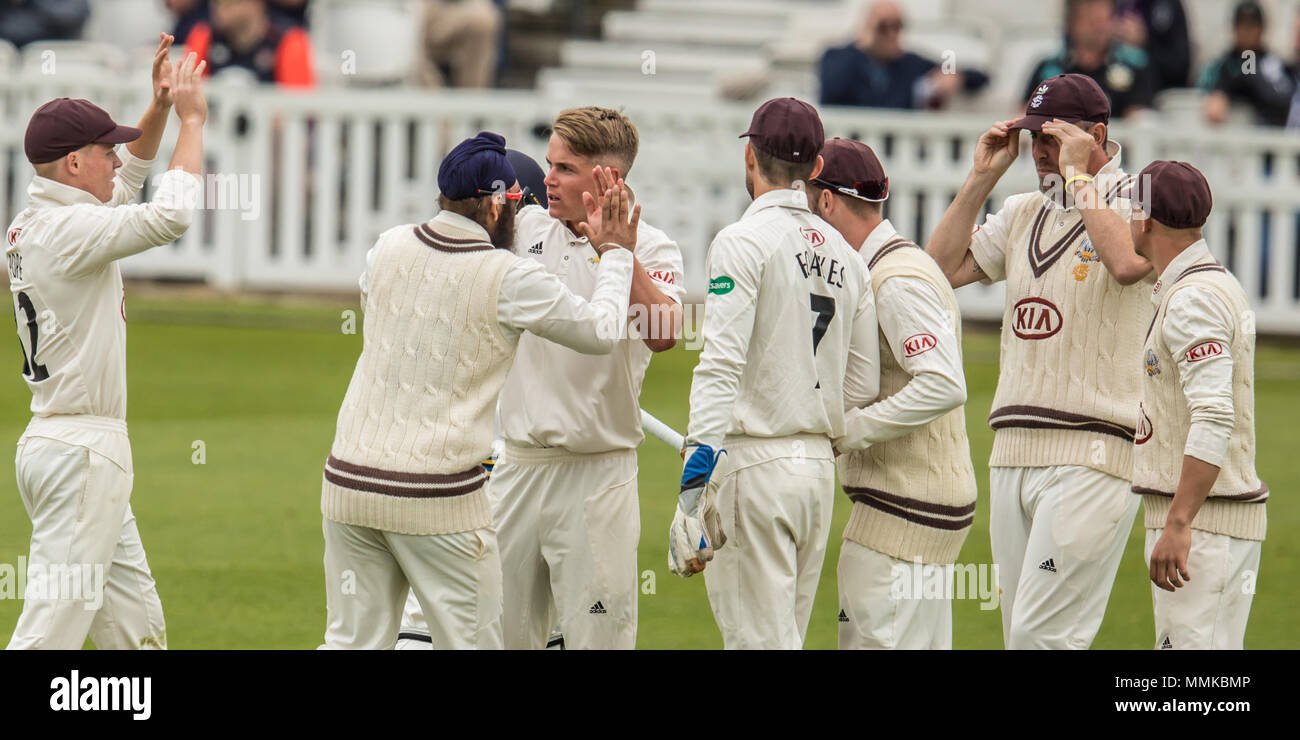 London,UK. 12 May, 2018. Sam Curran celebrates with his team mates after getting the wicket of Adam Lyth bowling for Surrey against Yorkshire on day two of the Specsavers County Championship game at the Oval. David Rowe/Alamy Live News Stock Photo
