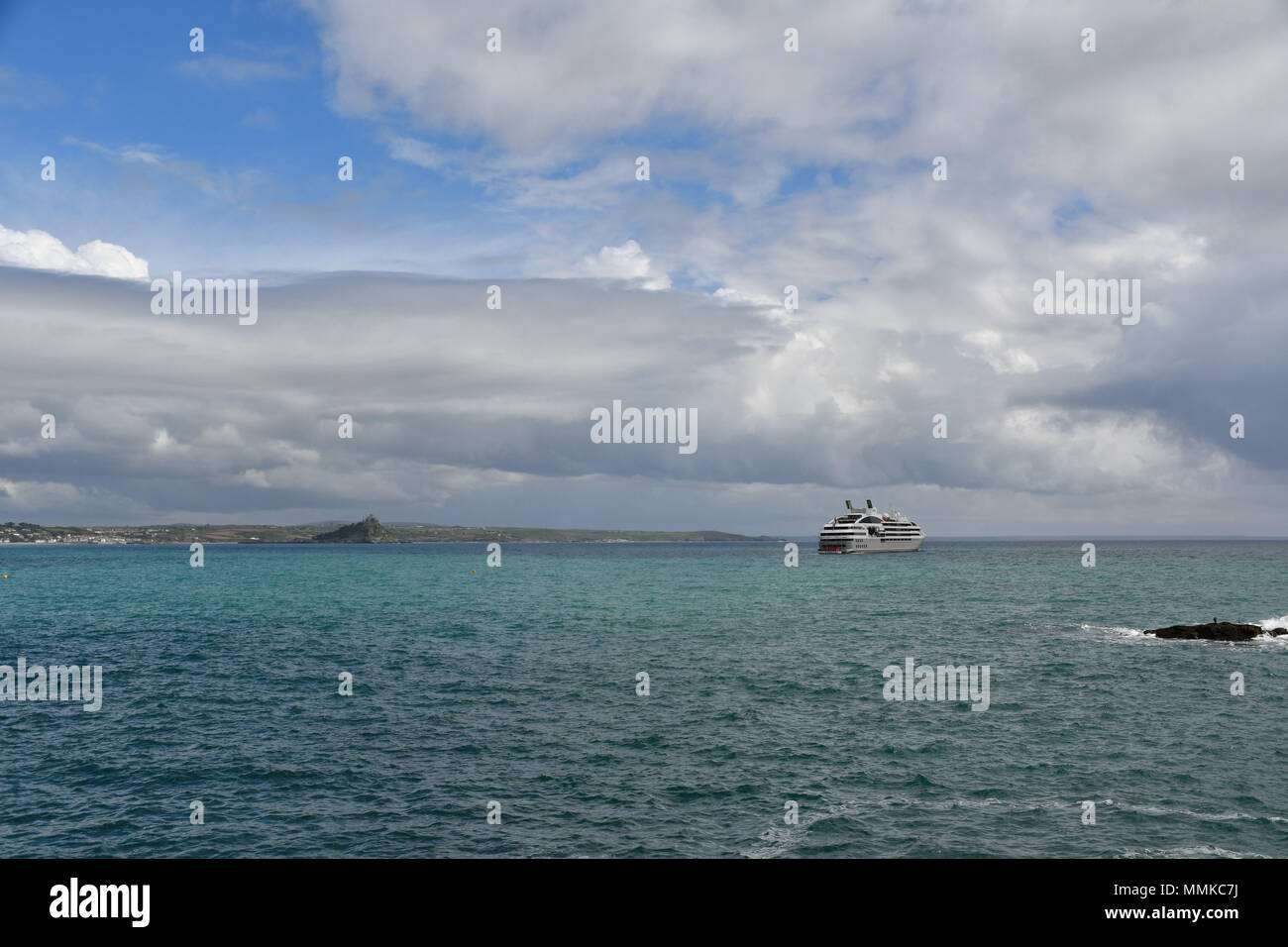 Penzance, Cornwall, UK. 12th May 2018. UK Weather. It was a mix of sunshine and showers for visitors from the French Cruise ship Le Soleal which was anchored in Mounts Bay this afternoon, near Penzance. Credit: Simon Maycock/Alamy Live News Stock Photo