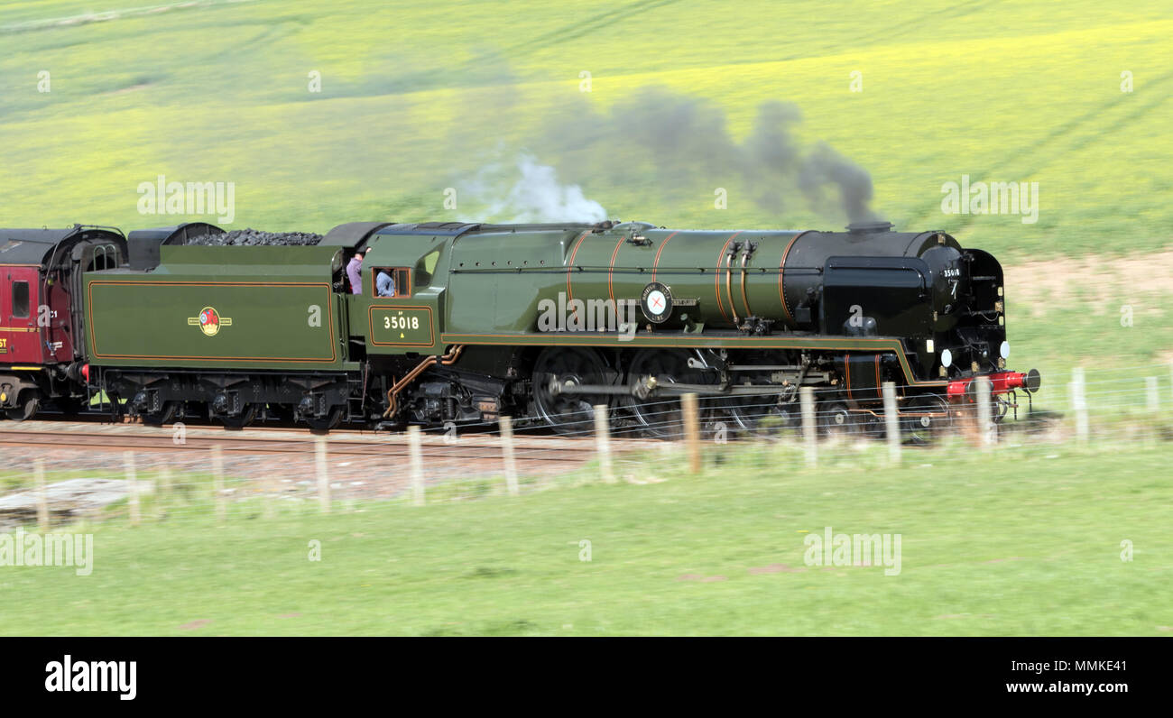 On a bright sunny summers day,Merchant Navy Class 'British India Line' steams through Cumbria near Armathwaite engine number 35018 on the Carlisle to Settle line. Stock Photo